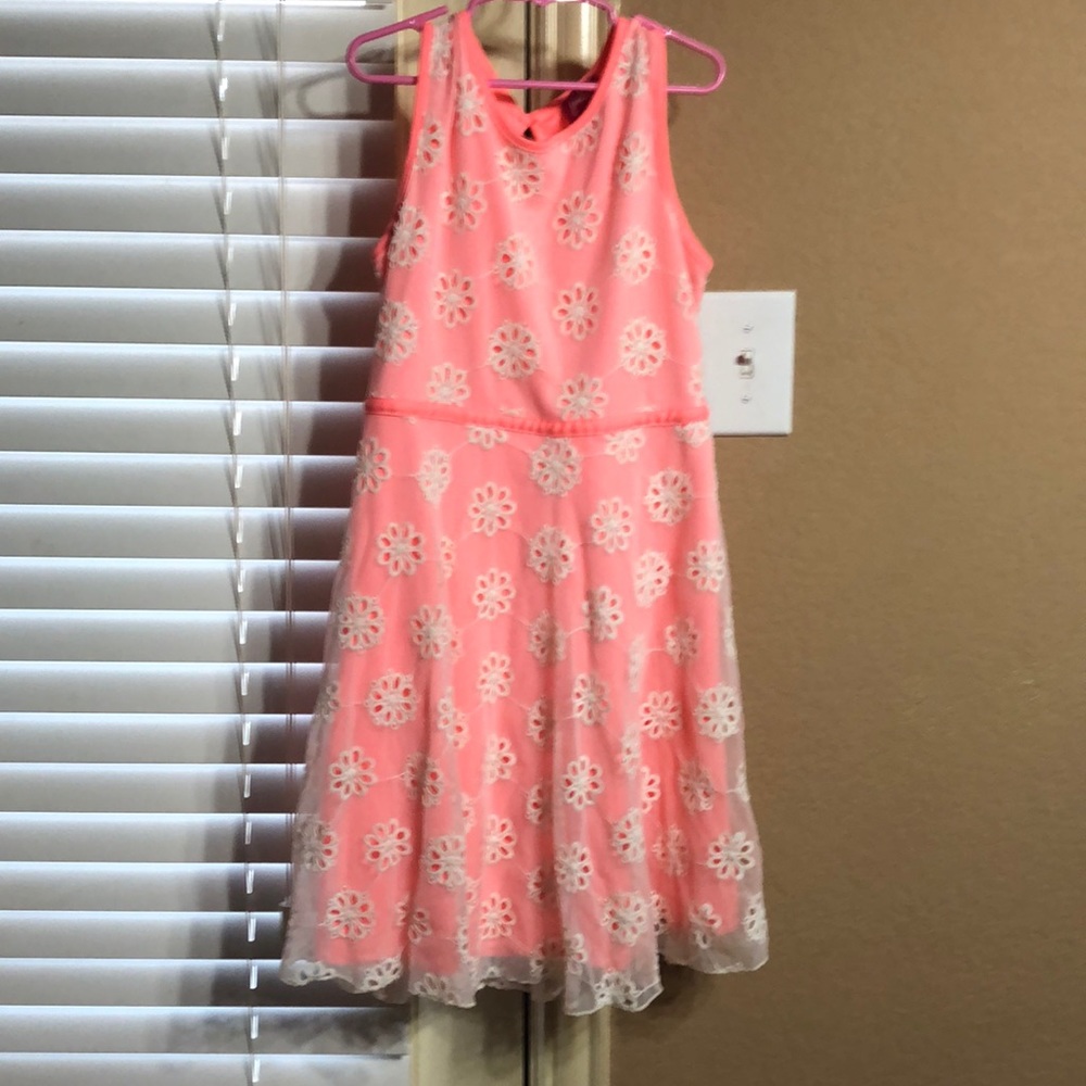 It’s a dress that is a coral pink and flowers.